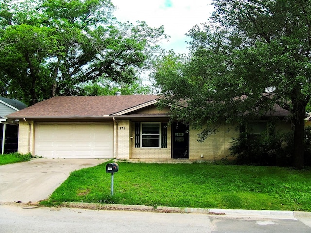 single story home featuring a garage, driveway, a front lawn, and brick siding