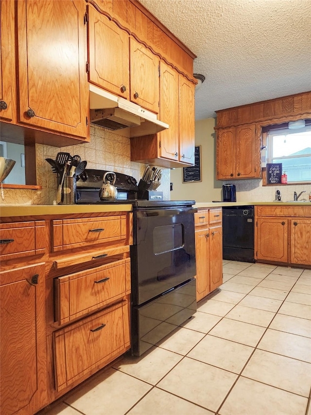 kitchen with decorative backsplash, black appliances, light tile patterned flooring, and under cabinet range hood
