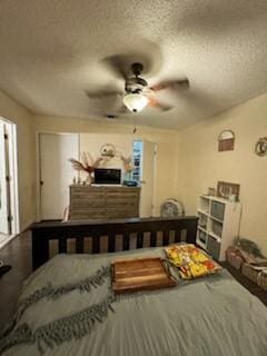 bedroom with a ceiling fan and a textured ceiling