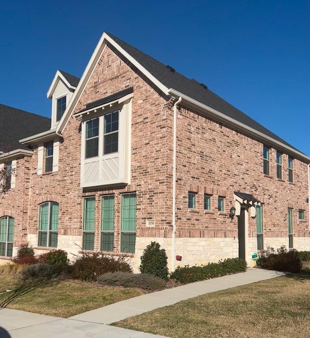 view of side of property with a lawn