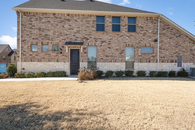 view of side of home featuring a lawn