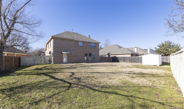 back of property with a shed and a lawn