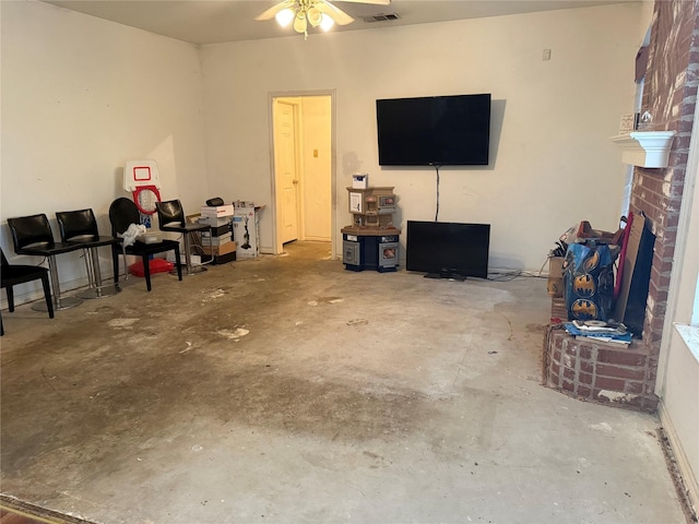 living room with ceiling fan and concrete floors