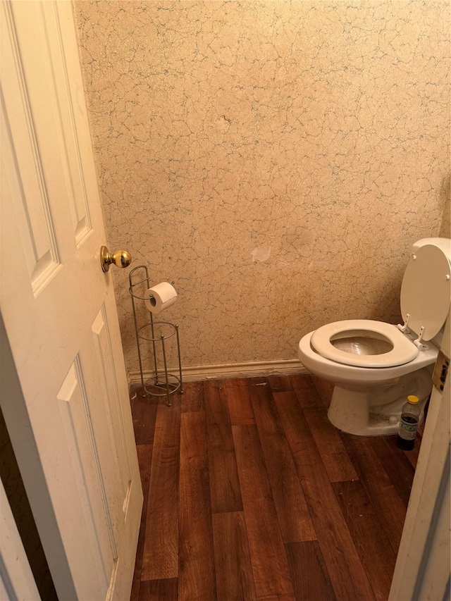 bathroom featuring wood-type flooring and toilet