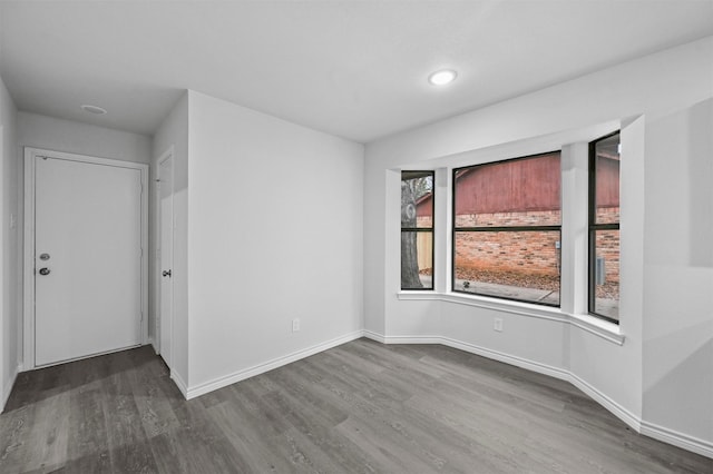 unfurnished room featuring hardwood / wood-style flooring