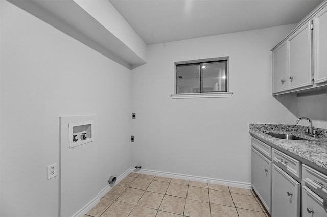 laundry area featuring cabinets, sink, hookup for a washing machine, hookup for an electric dryer, and light tile patterned floors