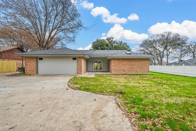 view of front of house with a front lawn and a garage