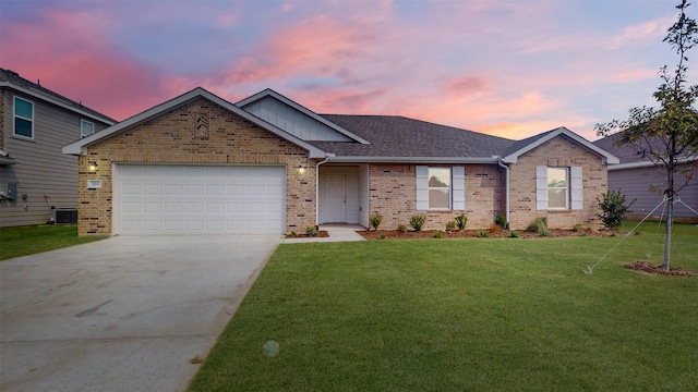 view of front facade featuring a garage, central air condition unit, and a yard