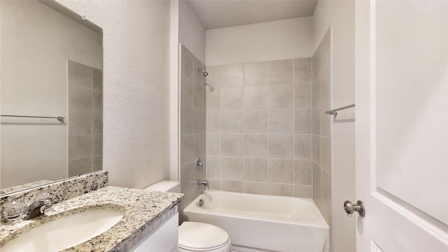 full bathroom with toilet, tiled shower / bath combo, and vanity