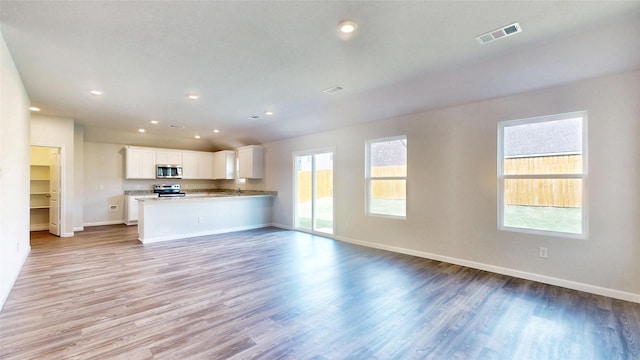 unfurnished living room featuring light wood-type flooring