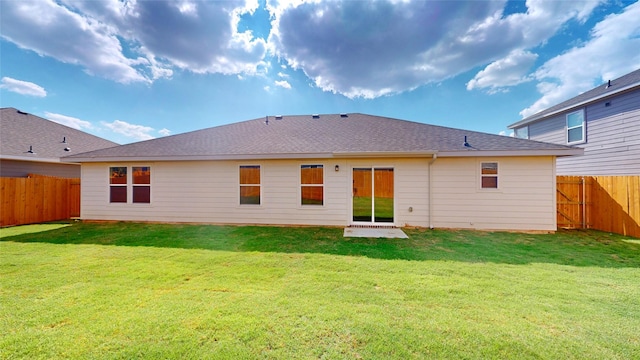 back of property featuring a lawn