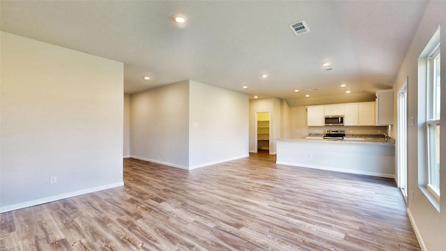 unfurnished living room featuring light wood-type flooring