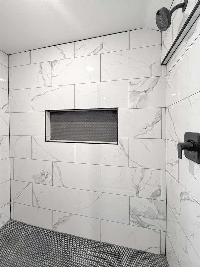 bathroom with a tile shower