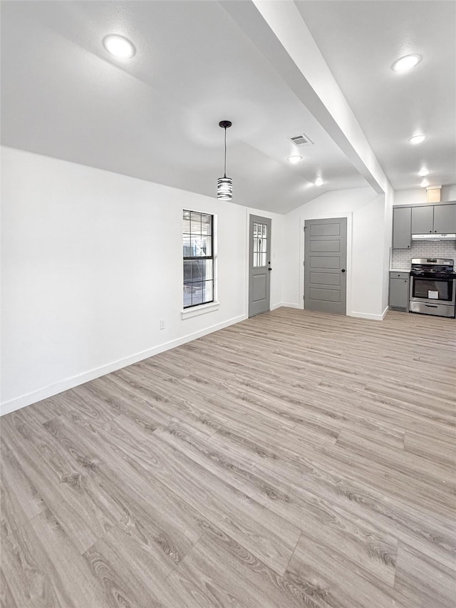 unfurnished living room featuring light hardwood / wood-style floors and lofted ceiling