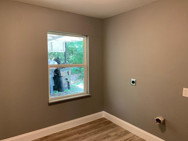 washroom featuring hookup for an electric dryer and hardwood / wood-style flooring