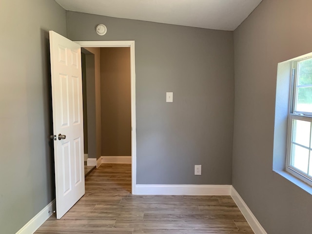 empty room with light hardwood / wood-style flooring