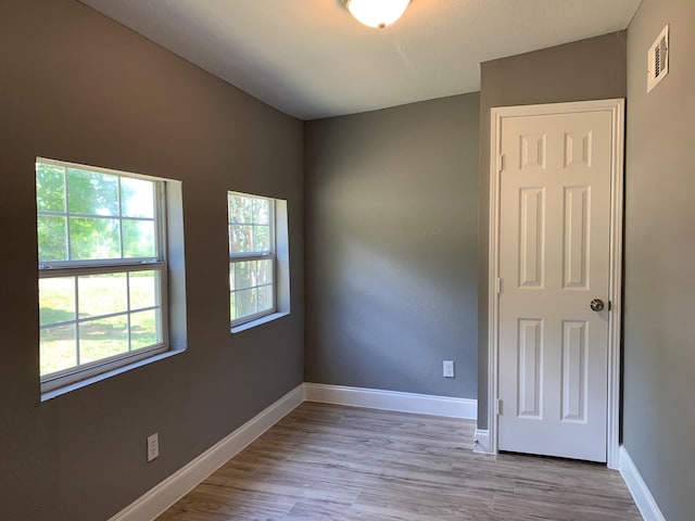 unfurnished room featuring light wood-type flooring