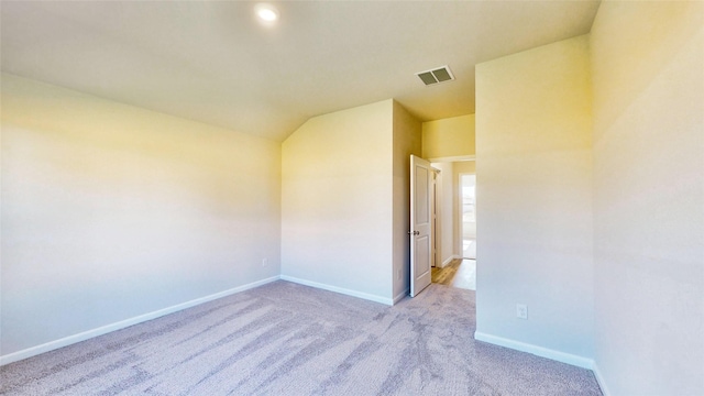 unfurnished room with light carpet and lofted ceiling