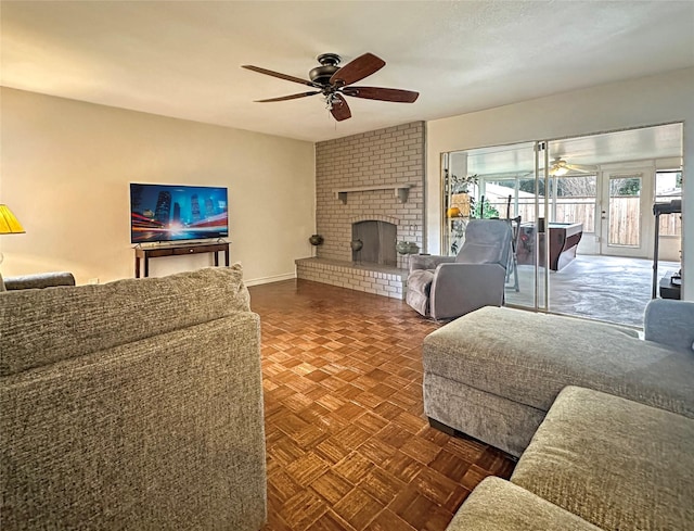 living room with ceiling fan, dark parquet floors, and a fireplace