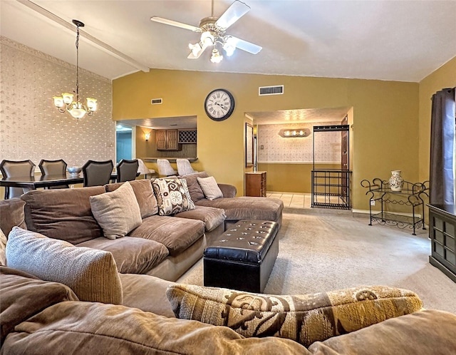 carpeted living room with ceiling fan with notable chandelier and vaulted ceiling with beams