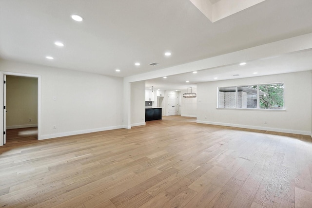 unfurnished living room featuring light wood-type flooring