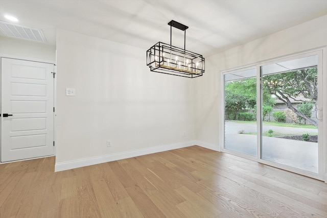 unfurnished dining area featuring light hardwood / wood-style flooring