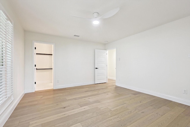 empty room with light wood-type flooring and ceiling fan