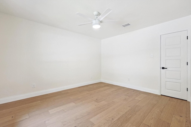 empty room featuring ceiling fan and light hardwood / wood-style flooring