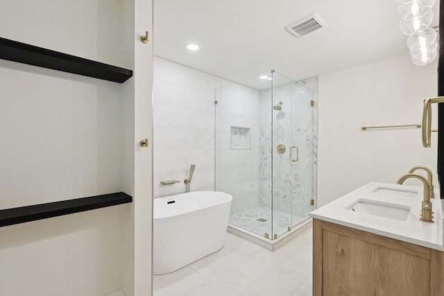 bathroom with tile patterned flooring, separate shower and tub, and vanity