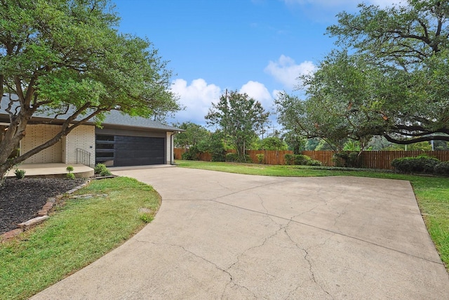 view of front of house with a front yard and a garage