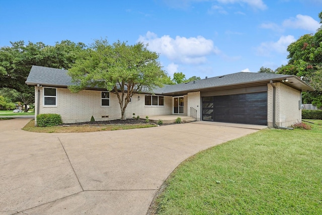 ranch-style house featuring a garage and a front lawn