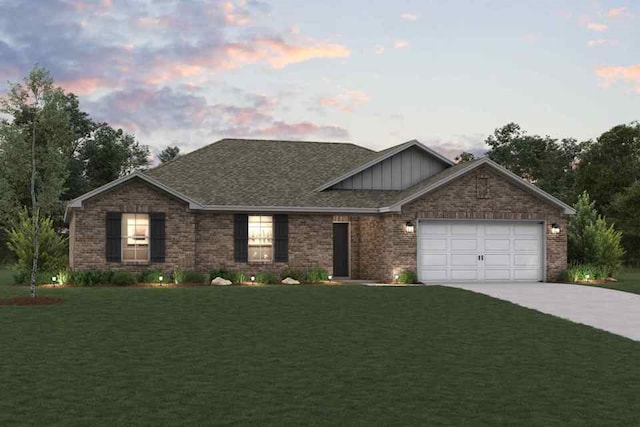 view of front of house with a yard and a garage