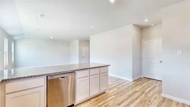 empty room with vaulted ceiling and light hardwood / wood-style flooring