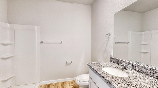 kitchen with stainless steel appliances, light wood-type flooring, vaulted ceiling, white cabinets, and sink