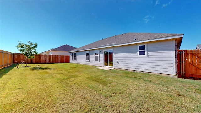 rear view of house featuring a lawn