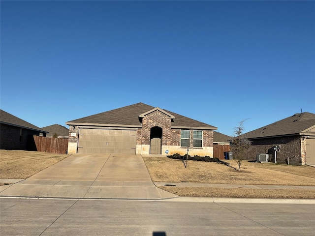 view of front of house featuring a garage and central AC