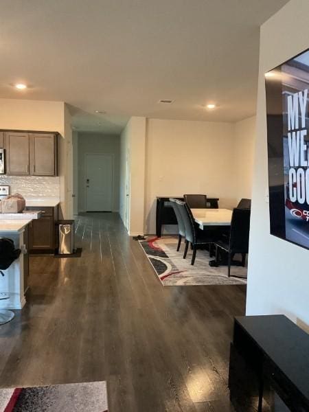 dining space featuring dark wood-type flooring