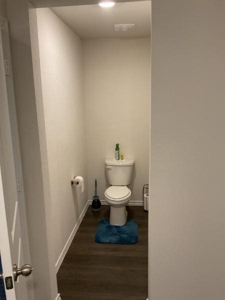 bathroom with toilet and hardwood / wood-style floors