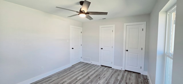 unfurnished bedroom with ceiling fan and light hardwood / wood-style flooring