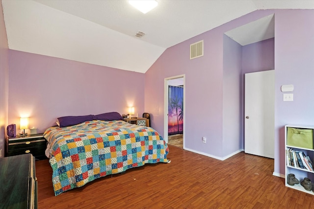 bedroom featuring vaulted ceiling and wood-type flooring