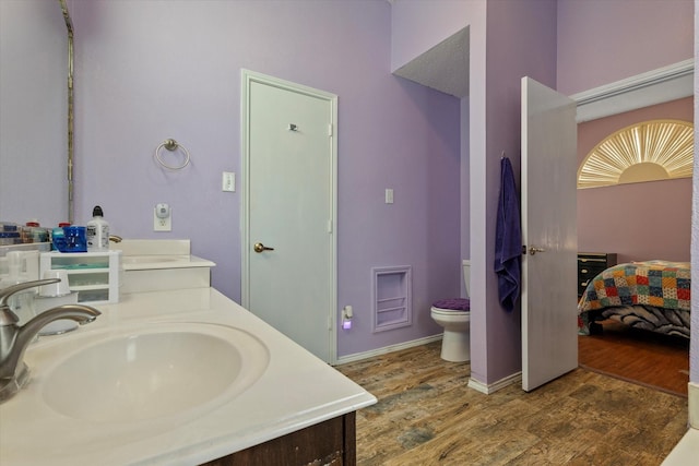 bathroom featuring hardwood / wood-style floors, toilet, and vanity