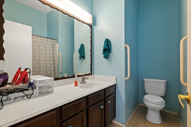 bathroom featuring toilet, tile patterned floors, and vanity