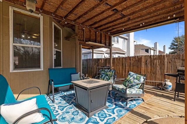 wooden terrace featuring an outdoor fire pit