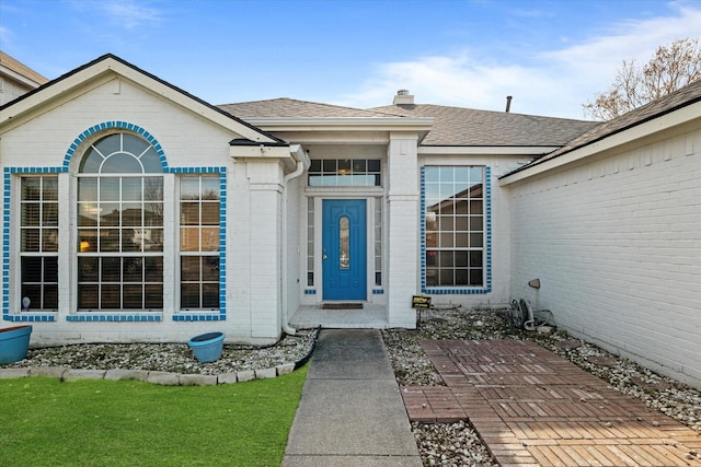 entrance to property with a lawn