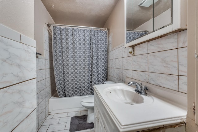 full bathroom featuring toilet, tile walls, shower / bath combination with curtain, a textured ceiling, and vanity