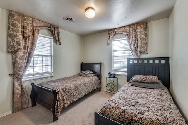 carpeted bedroom featuring multiple windows