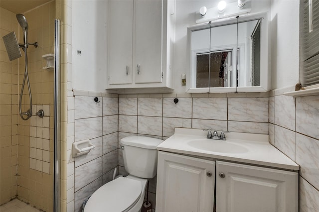 bathroom with toilet, vanity, tile walls, and a shower with door