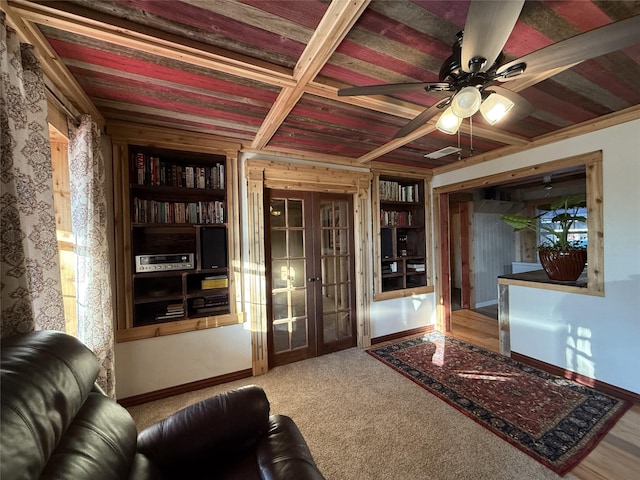 living room featuring ceiling fan and french doors