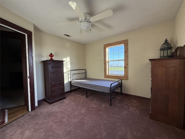 carpeted bedroom with a textured ceiling and ceiling fan