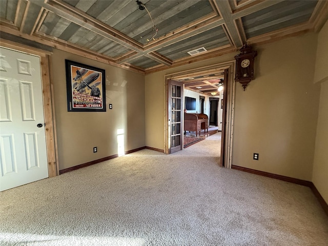 unfurnished room featuring coffered ceiling and carpet flooring